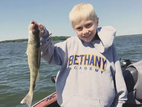 Young angler with a fish caught on a guided trip
